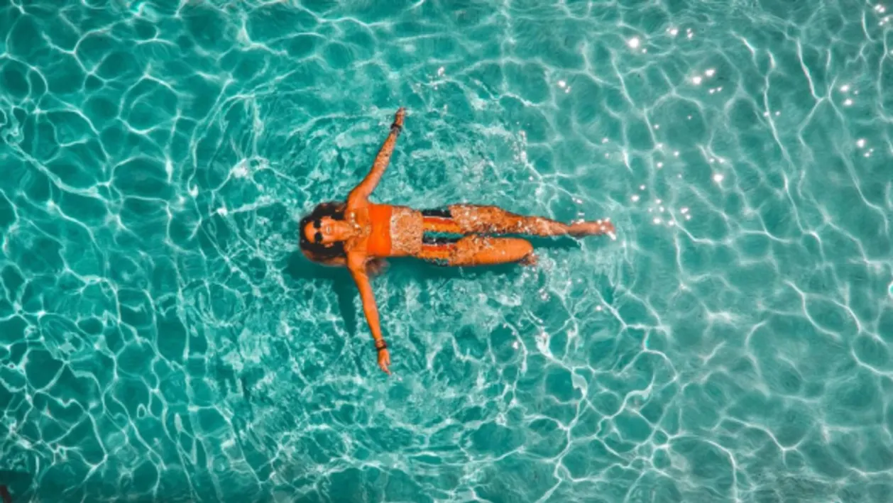 aerial of woman floating in pool